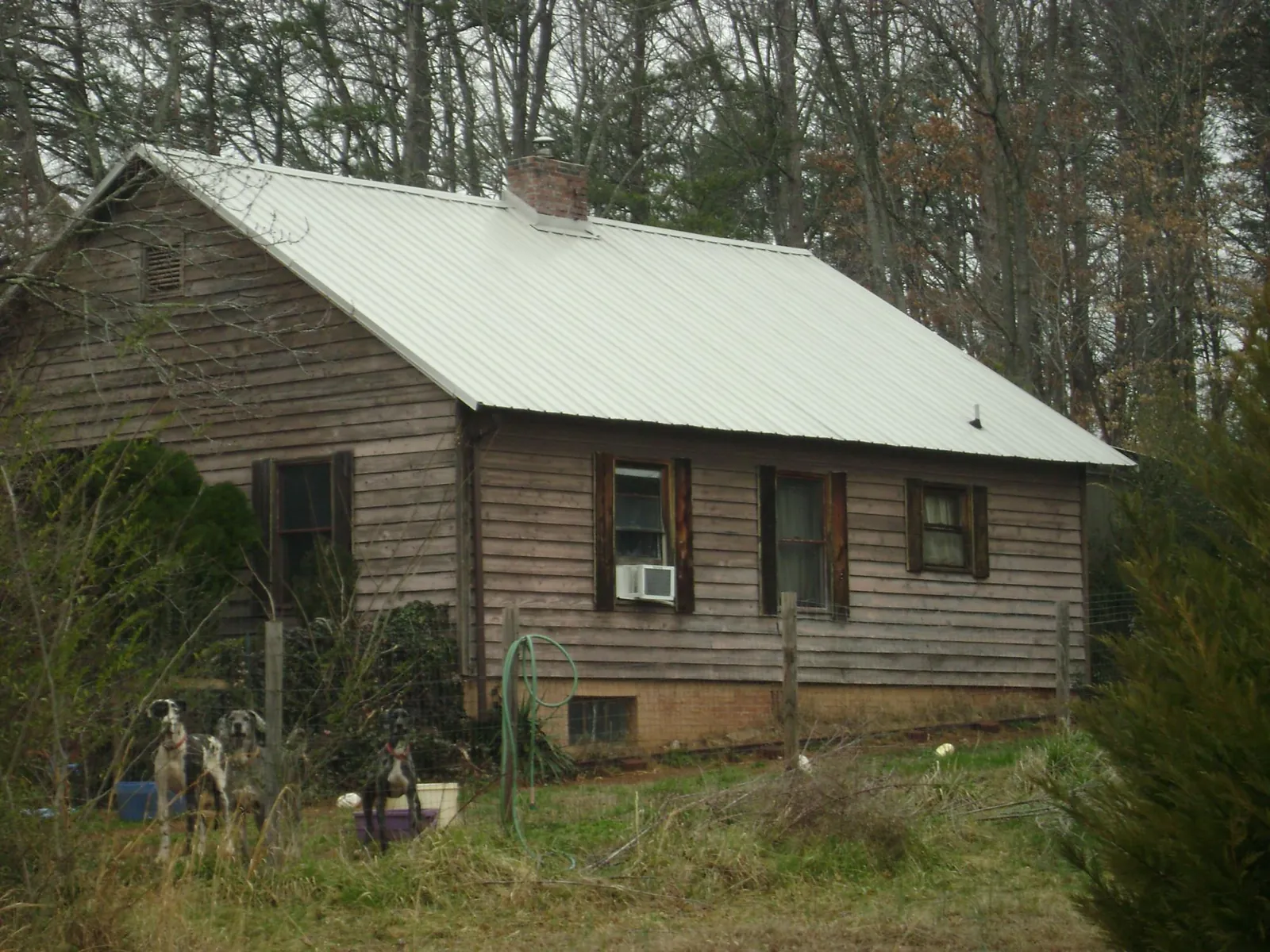White metal roof on an old wood sided farmhouse, from a Metal Roof Installation job in Emory